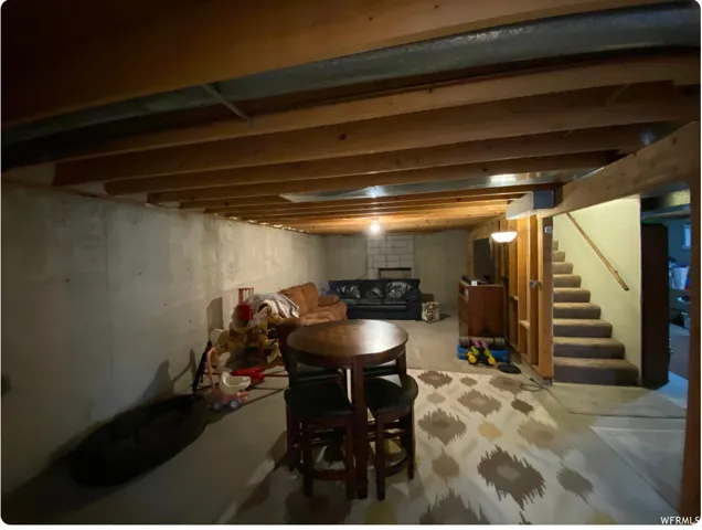 Unfinished below grade area featuring stairway