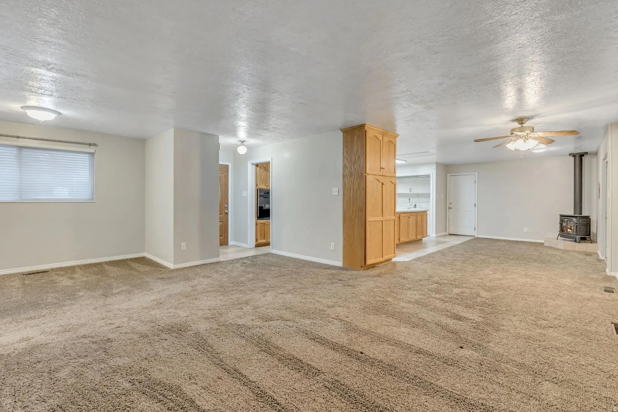 Open main-floor living area with flexible layout and natural light, providing ample space for gathering, relaxing, or reconfiguring for modern updates.