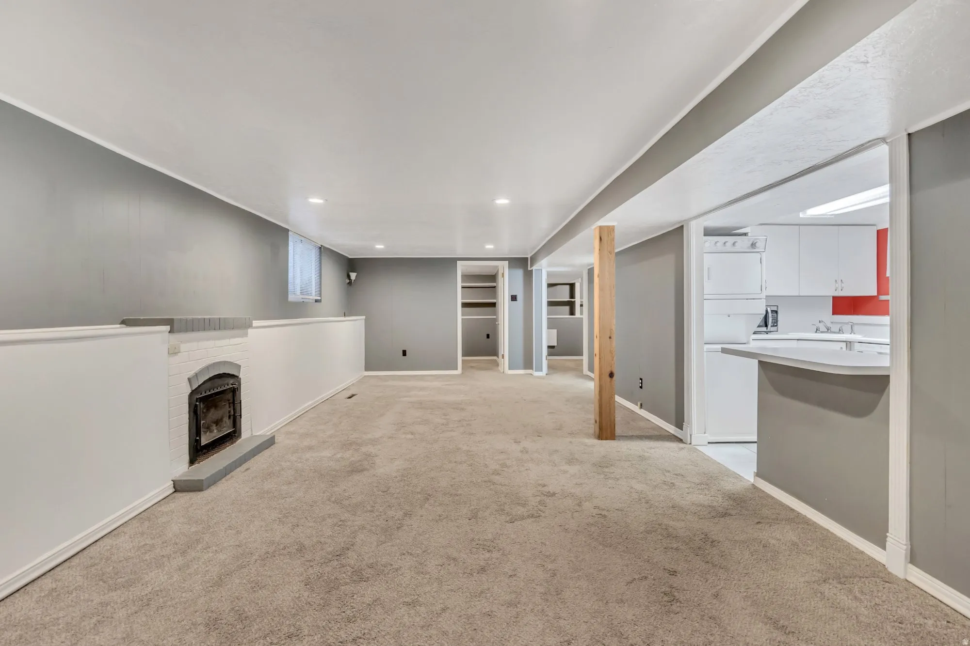 Large lower-level living area with open layout and recessed lighting, ideal for separate living quarters or flexible bonus space.