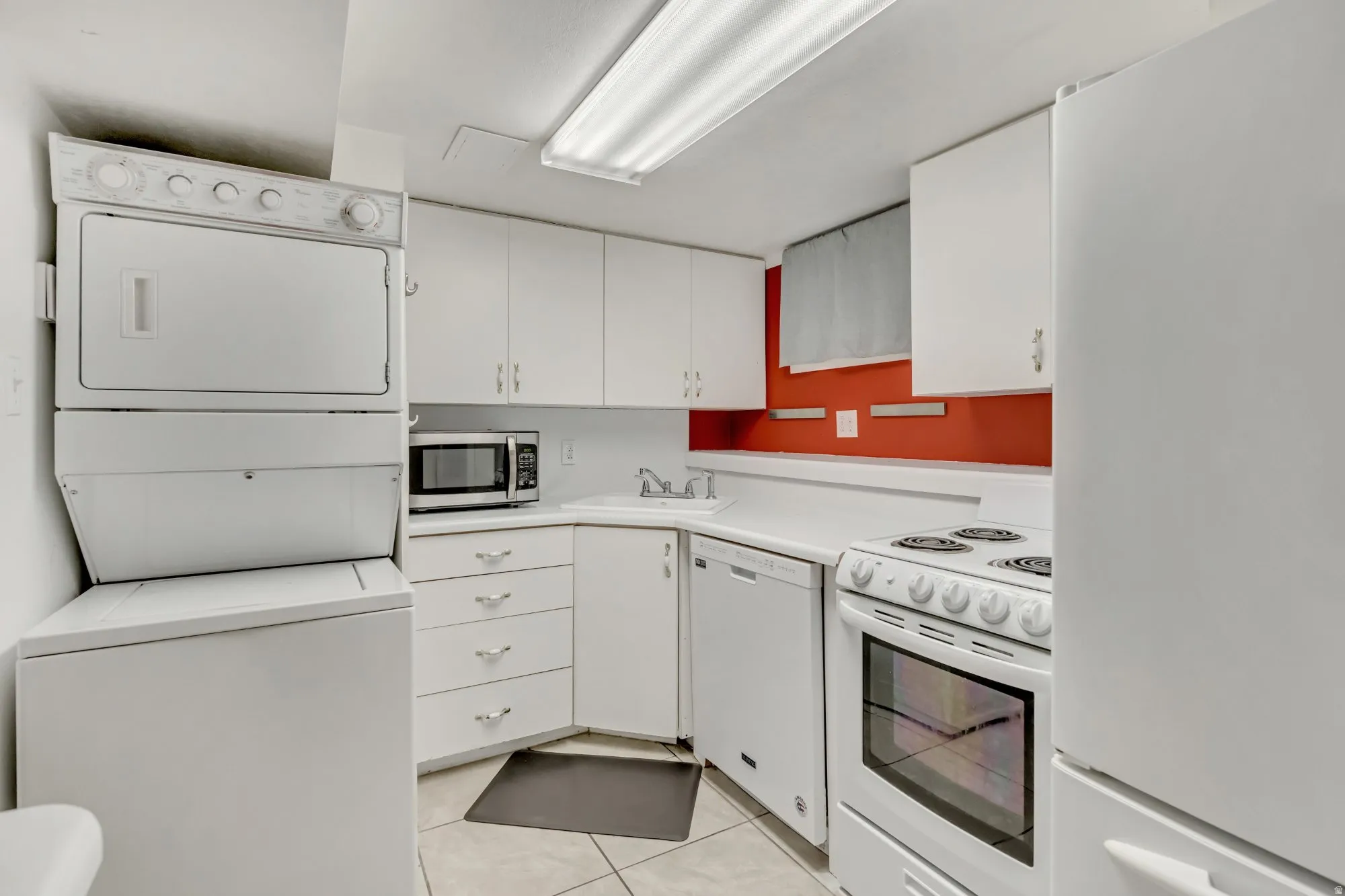 Lower-level kitchen area with cabinetry, appliances, and dedicated workspace, enhancing the functionality of the finished basement layout.