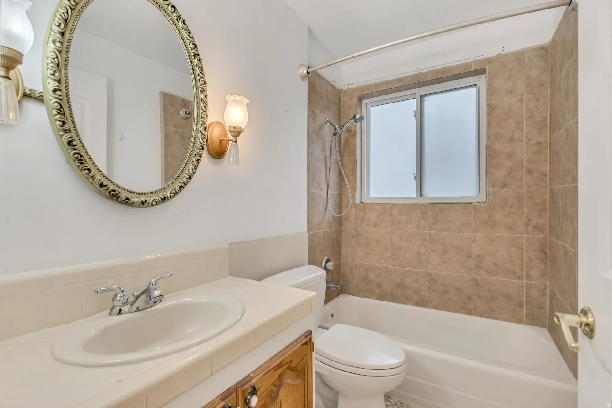 Full main-level bathroom with vanity storage and tiled tub/shower surround, serving the upstairs bedroom layout.