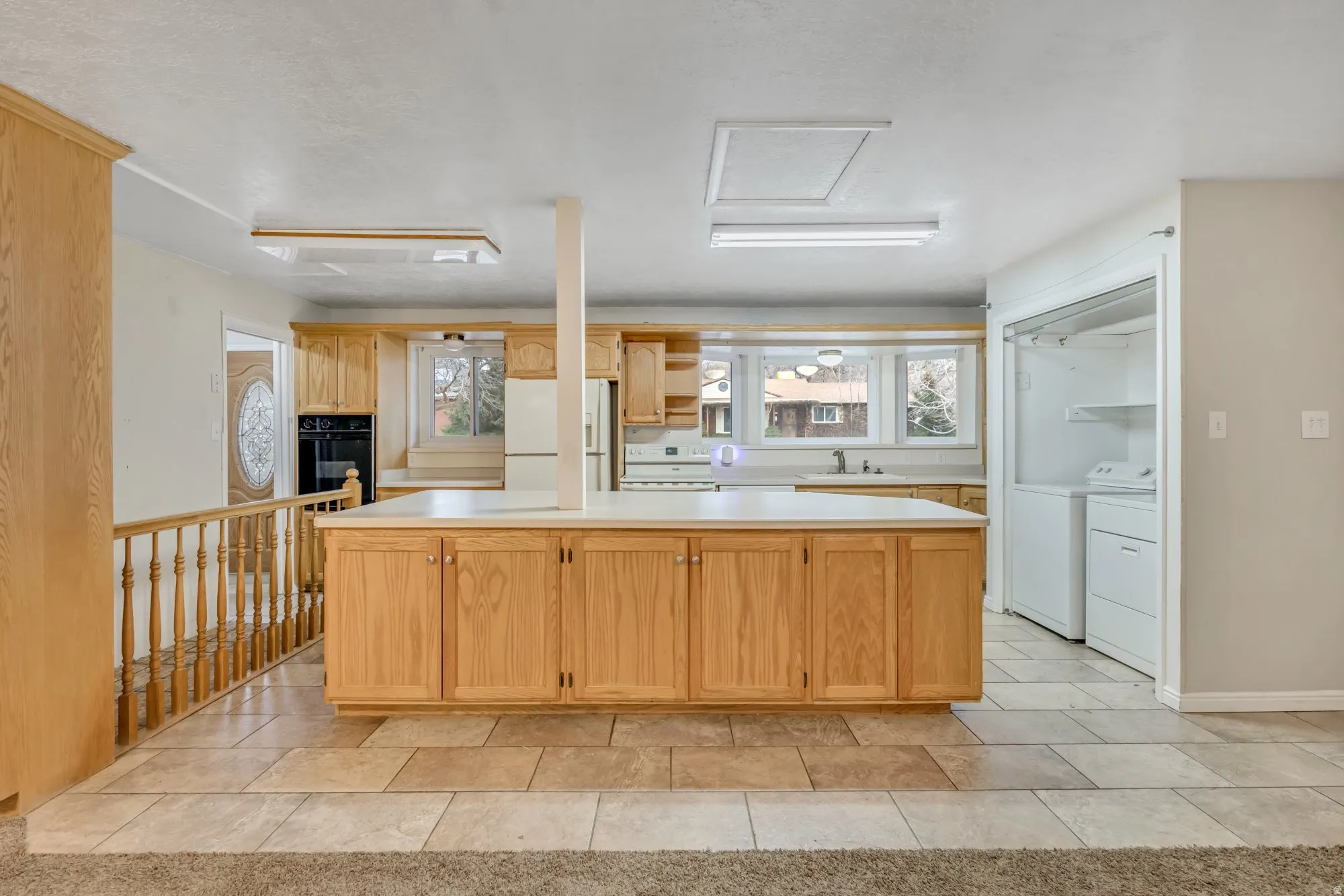 Spacious main-floor kitchen with extended peninsula and open sightlines into the living area, creating a functional layout ideal for everyday living or entertaining.