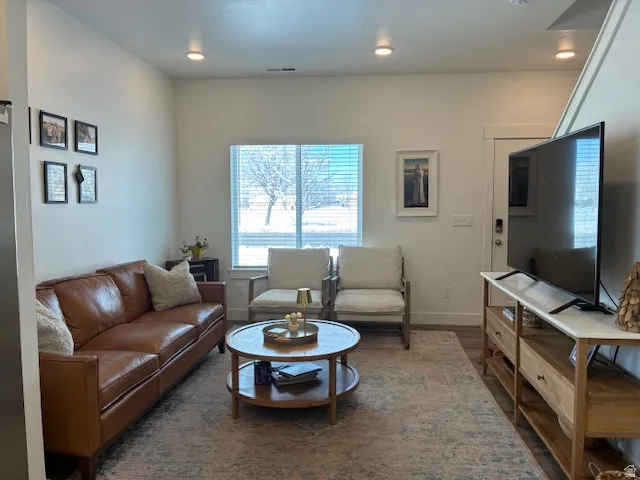 Living room featuring wood finished floors and recessed lighting