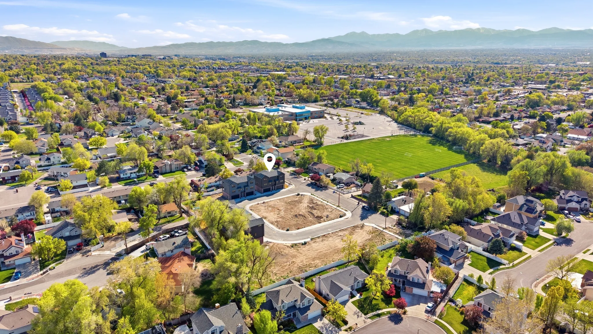 Aerial perspective of suburban area featuring a mountainous background