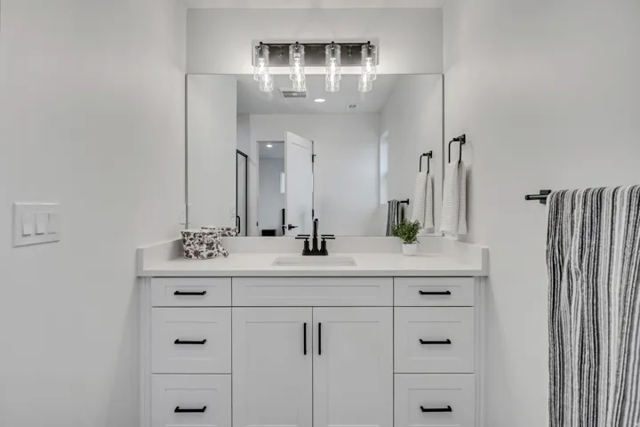 Bathroom featuring vanity and a stall shower