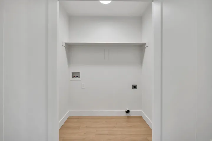 Laundry area featuring light wood-type flooring, hookup for an electric dryer, and washer hookup
