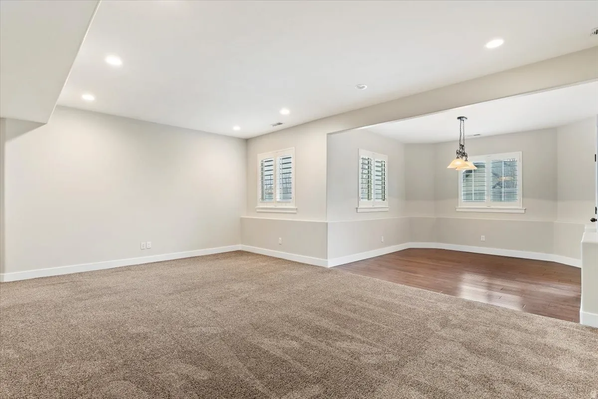 Empty room featuring light colored carpet and recessed lighting