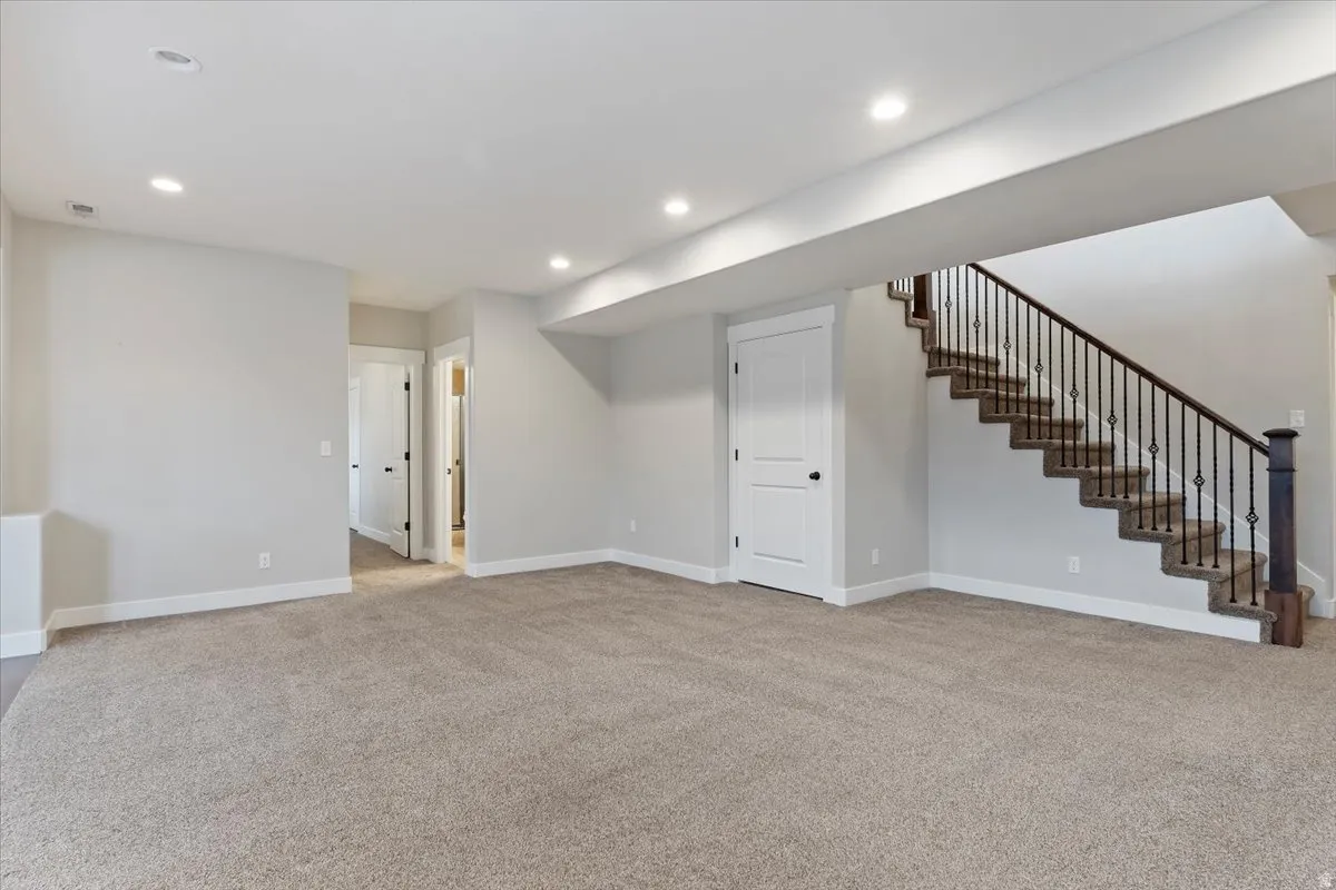 Finished below grade area featuring light carpet and recessed lighting