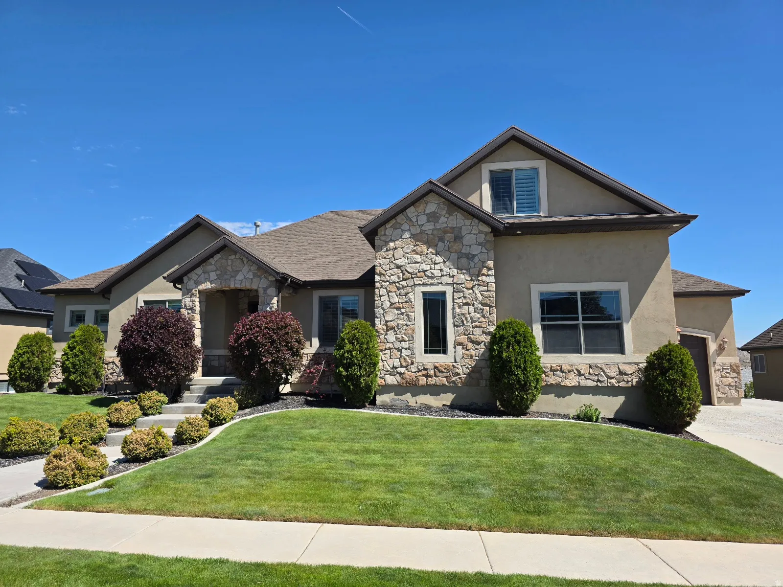 Stone and stucco exterior with a prominent front entrance