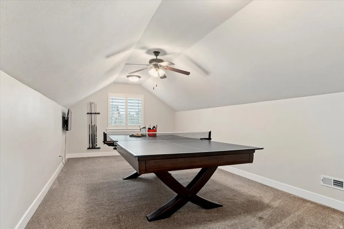 Game room featuring light colored carpet and ceiling fan