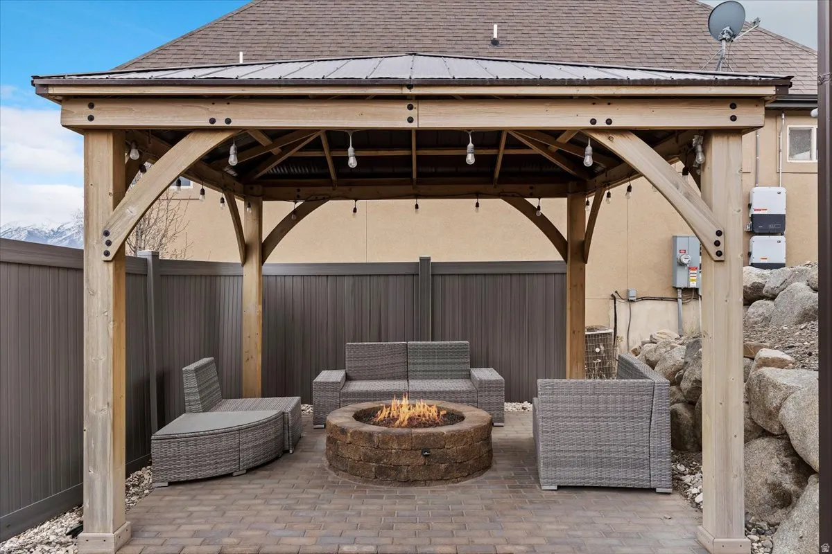 View of patio / terrace featuring a gazebo and an outdoor fire pit