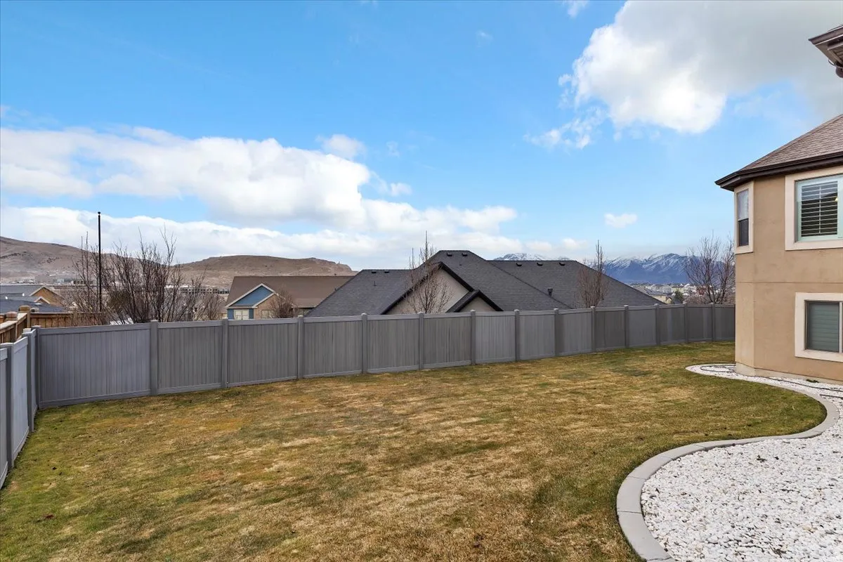 Fenced backyard with a mountain view