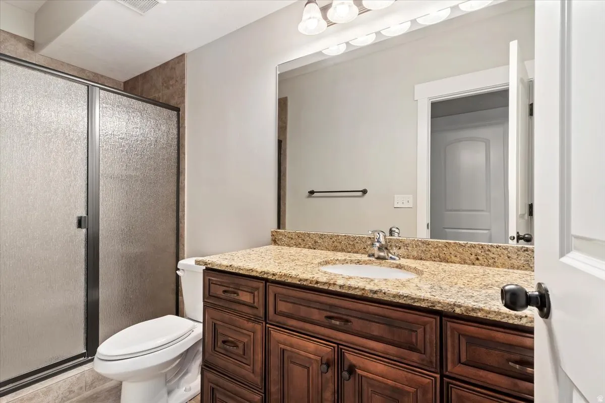 Bathroom featuring vanity and a shower stall