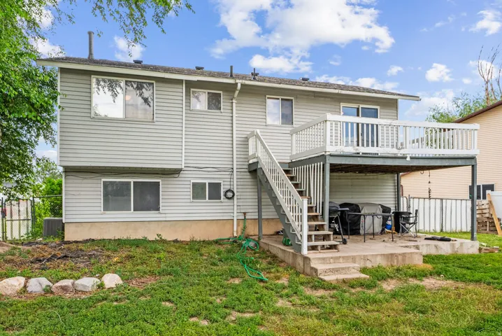 Rear view of house with a deck and a patio area