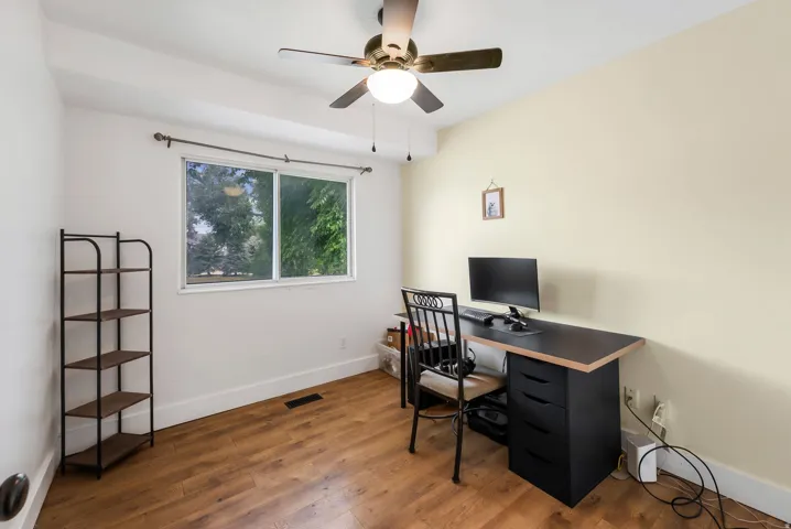 Office featuring wood finished floors and ceiling fan