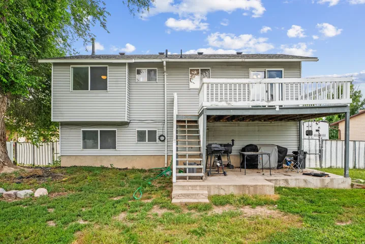 Back of property with a patio and a wooden deck