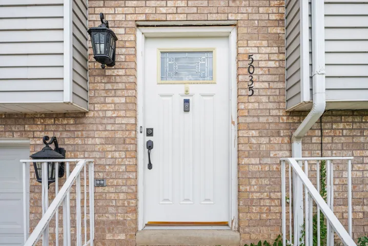 View of exterior entry with brick siding