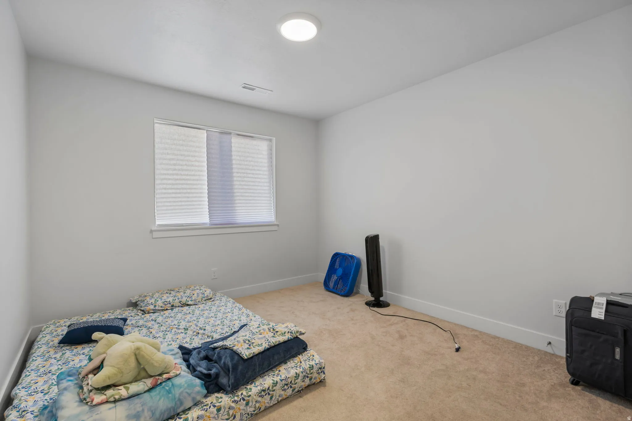 Bedroom featuring baseboards and carpet floors