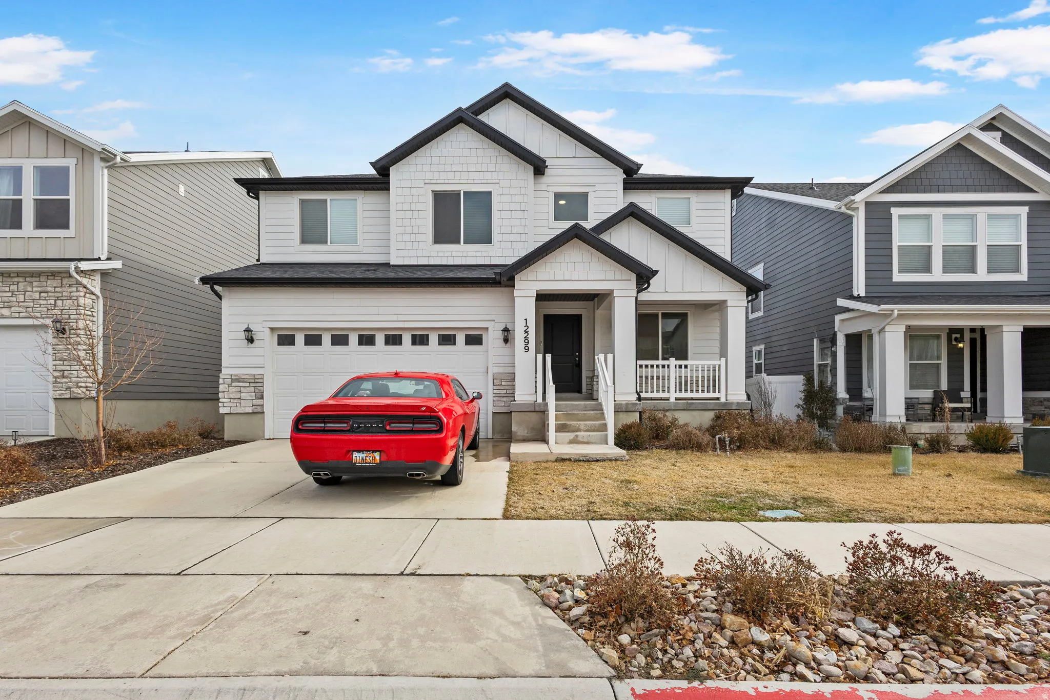 Craftsman-style home featuring board and batten siding, an attached garage, and concrete driveway