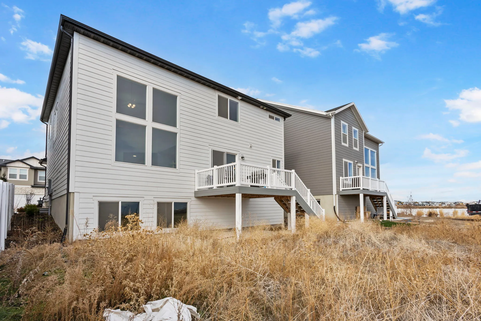 Back of house featuring stairway and a wooden deck