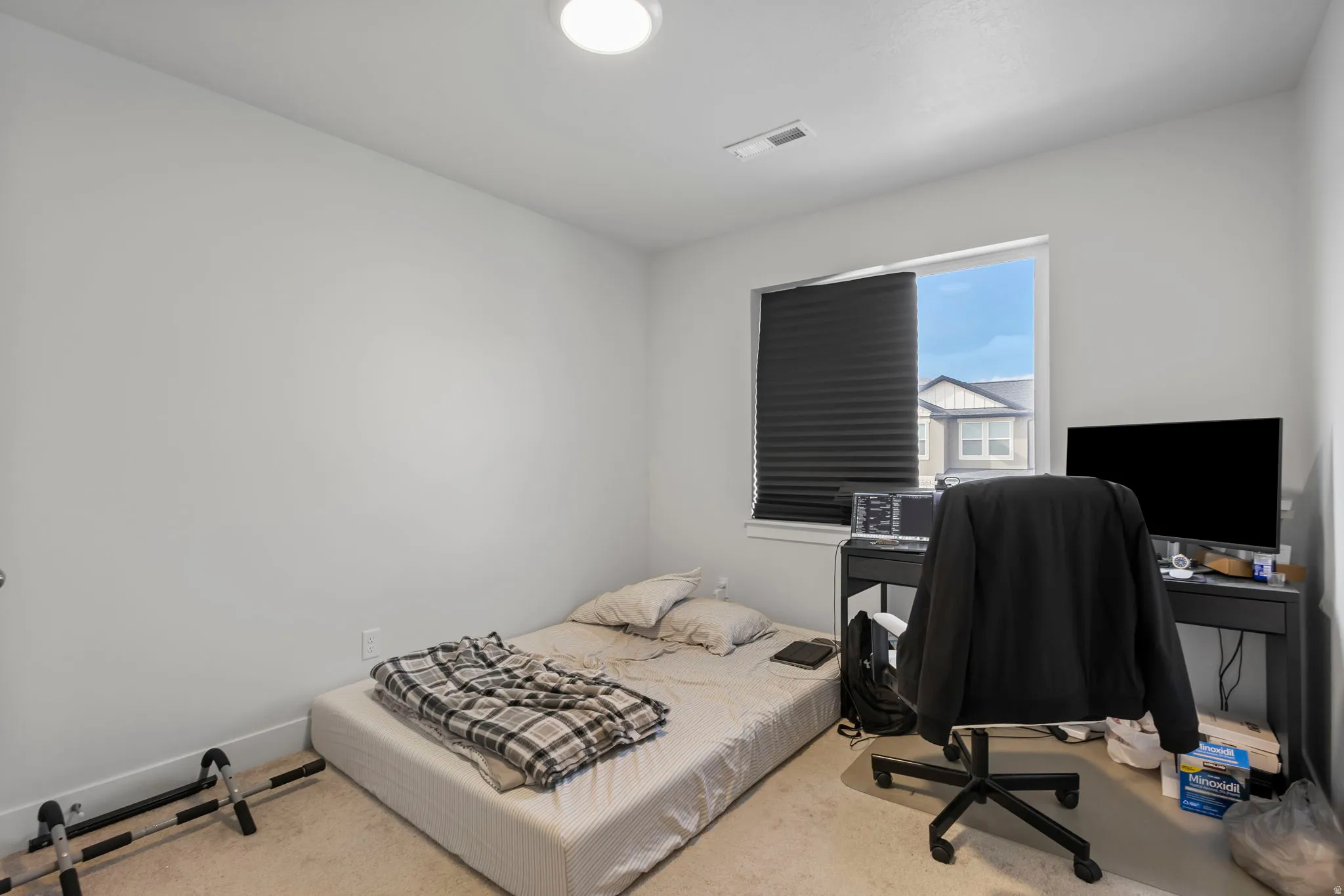 Carpeted bedroom with an office area