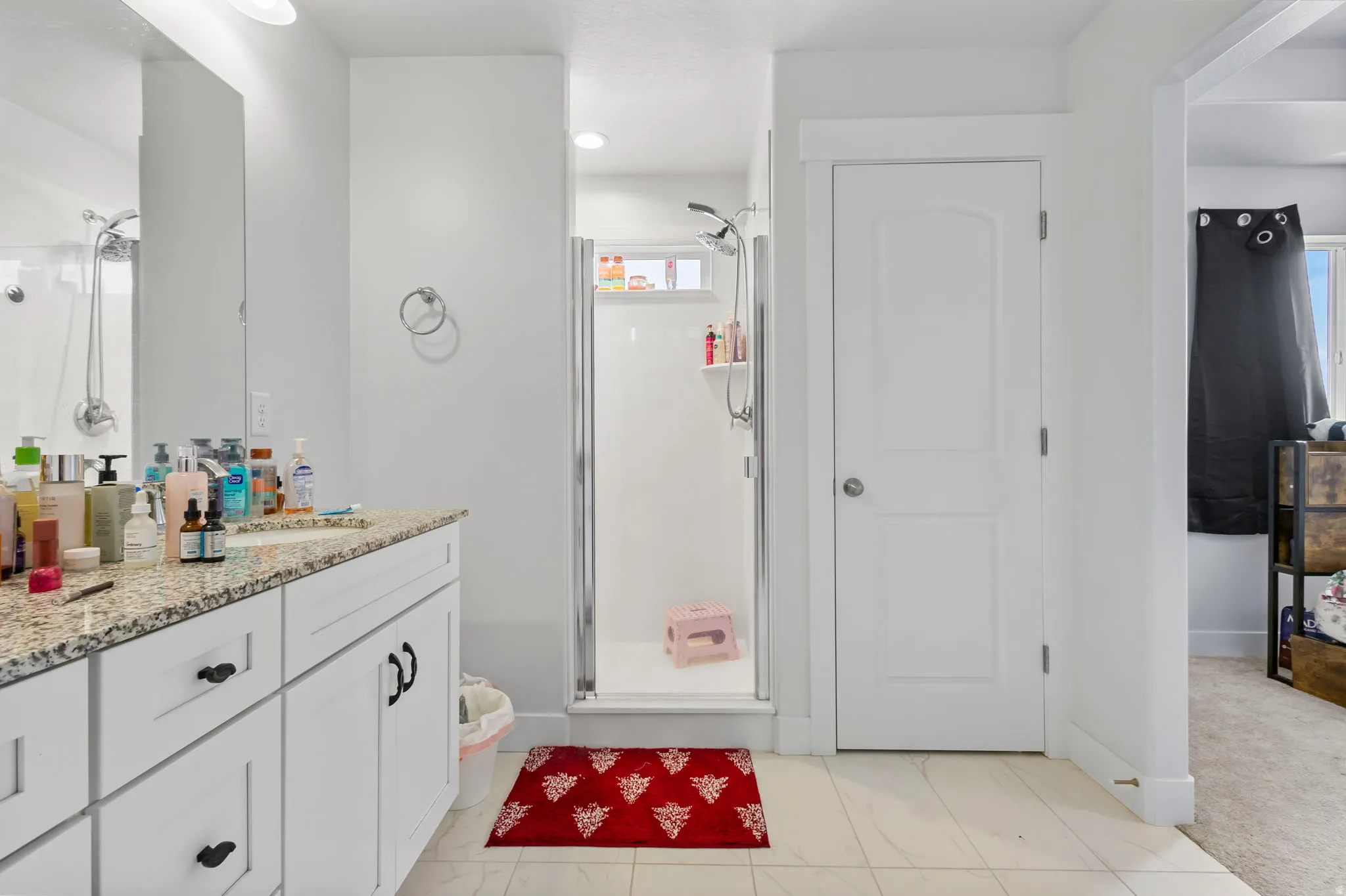 Bathroom featuring vanity and a shower stall