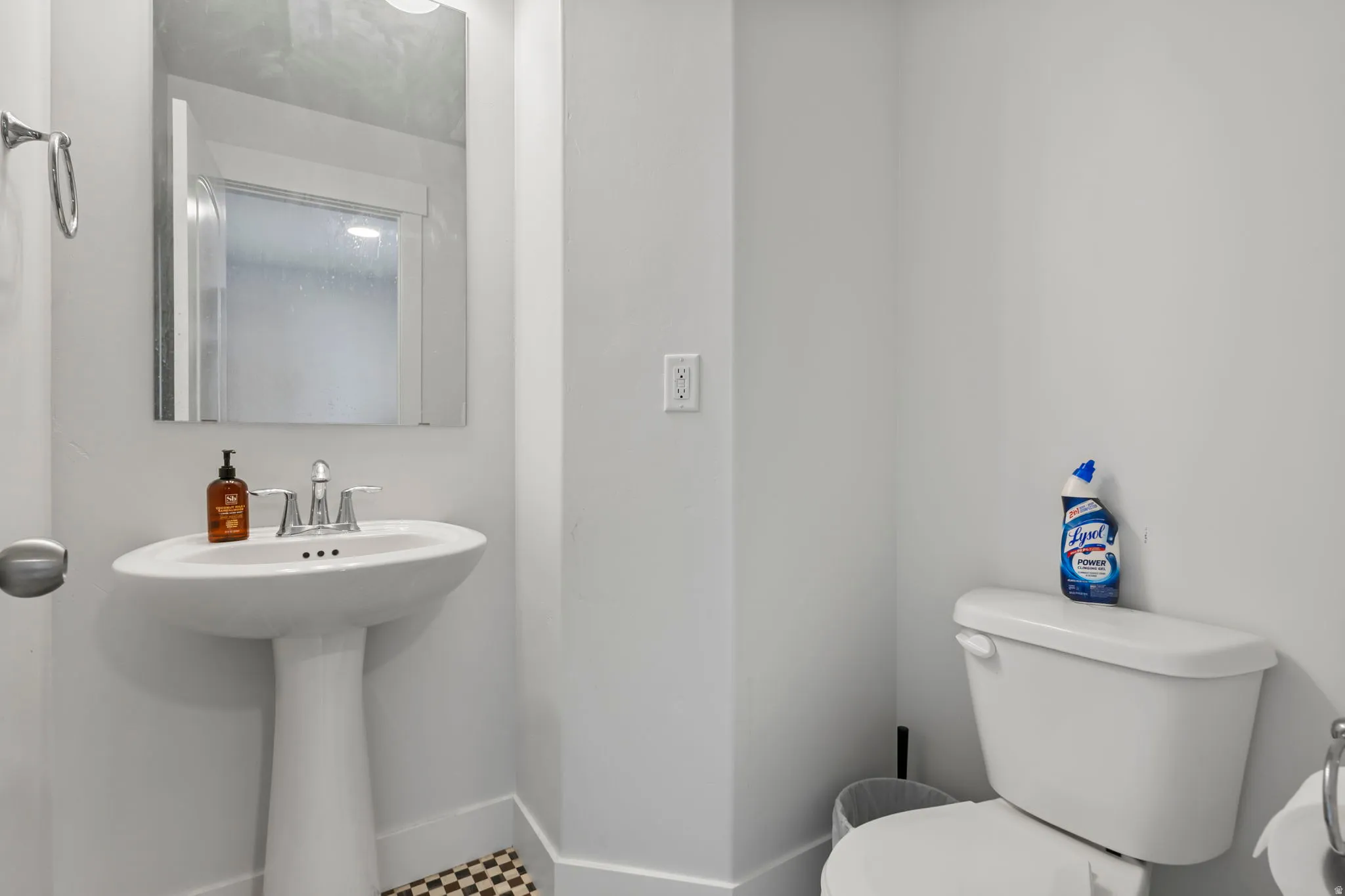 Half bath with toilet and baseboards