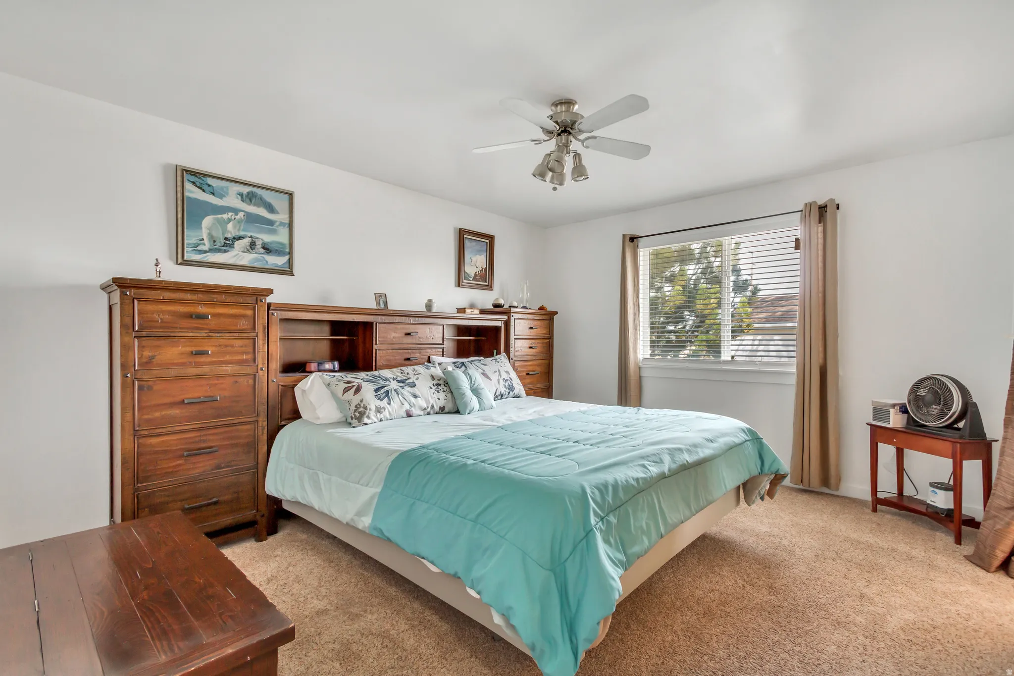 Bedroom featuring light carpet and ceiling fan