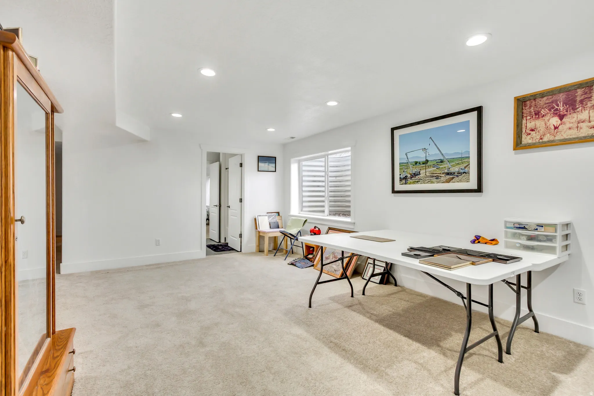 Office featuring light colored carpet and recessed lighting