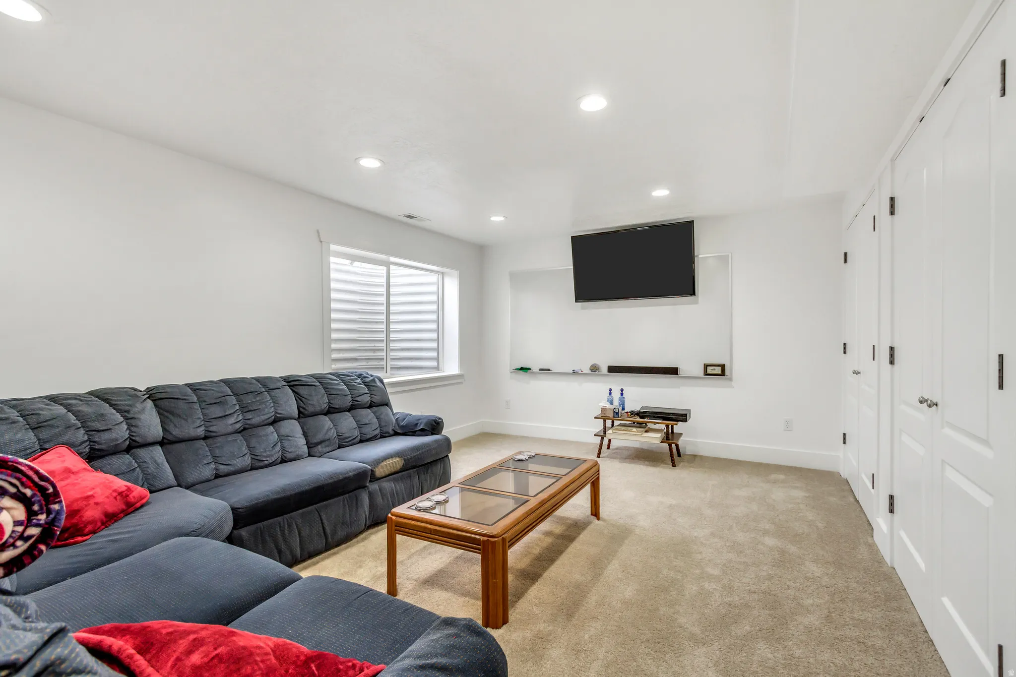 Living room with light carpet and recessed lighting