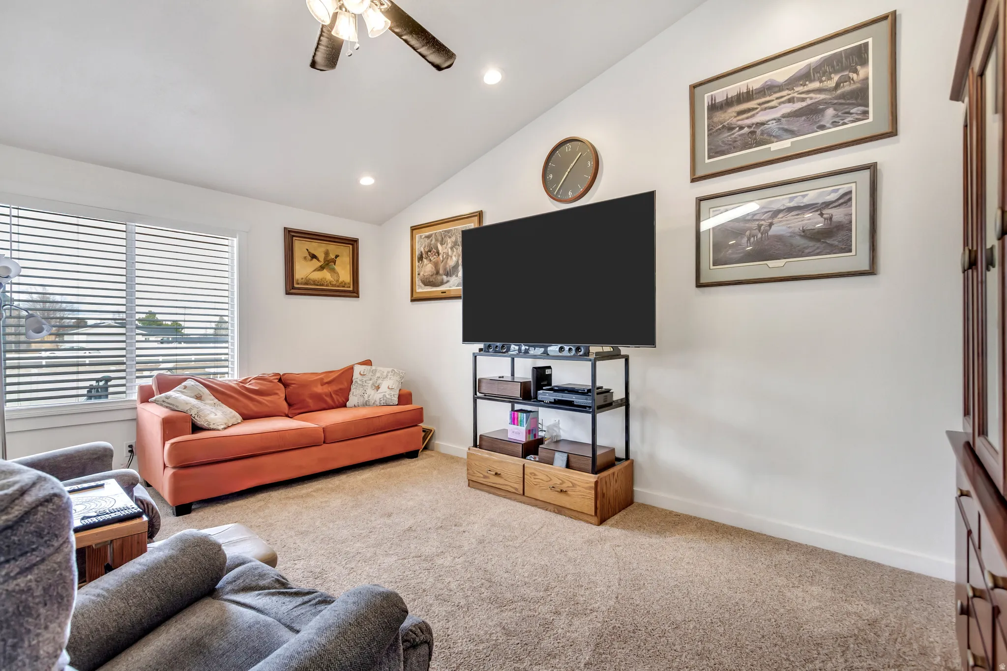 Living area with a ceiling fan, vaulted ceiling, carpet flooring, and recessed lighting