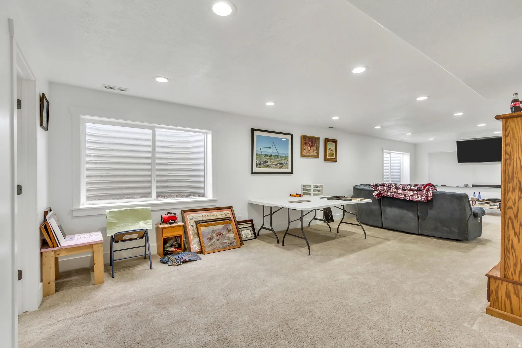 Living room with light colored carpet and recessed lighting