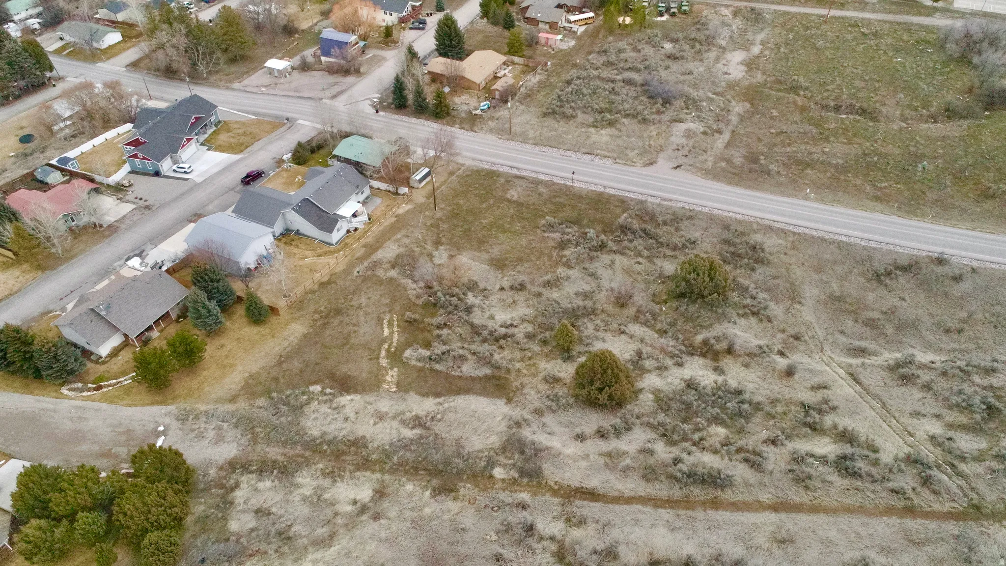 Aerial view of property's location with nearby suburban area