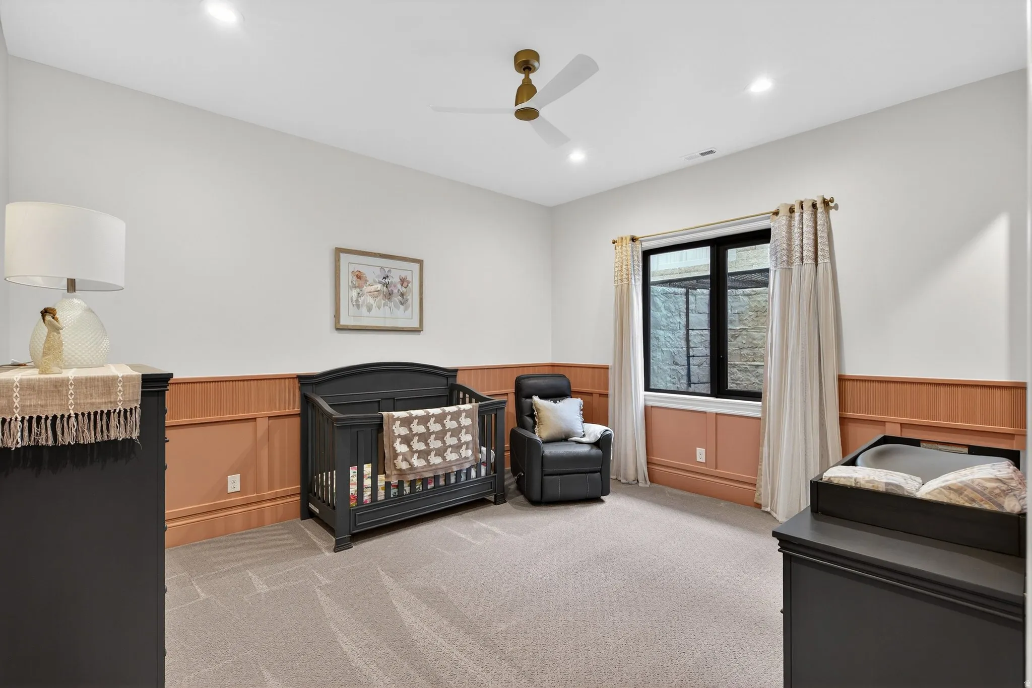 Lower Level Bedroom featuring a wainscoted wall, ceiling fan, recessed lighting, carpet flooring