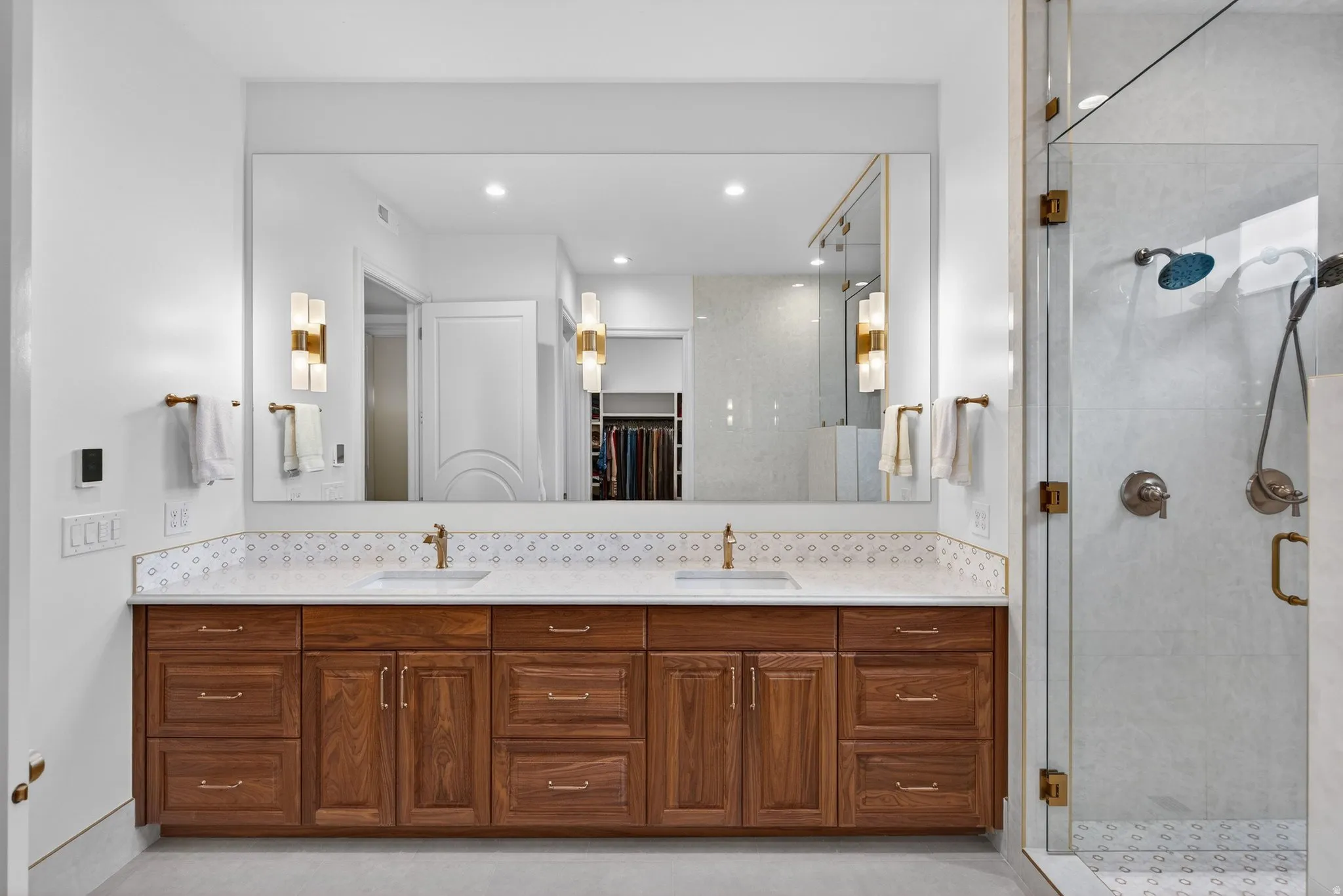 Lower Level Primary Bath featuring double vanity, double head shower