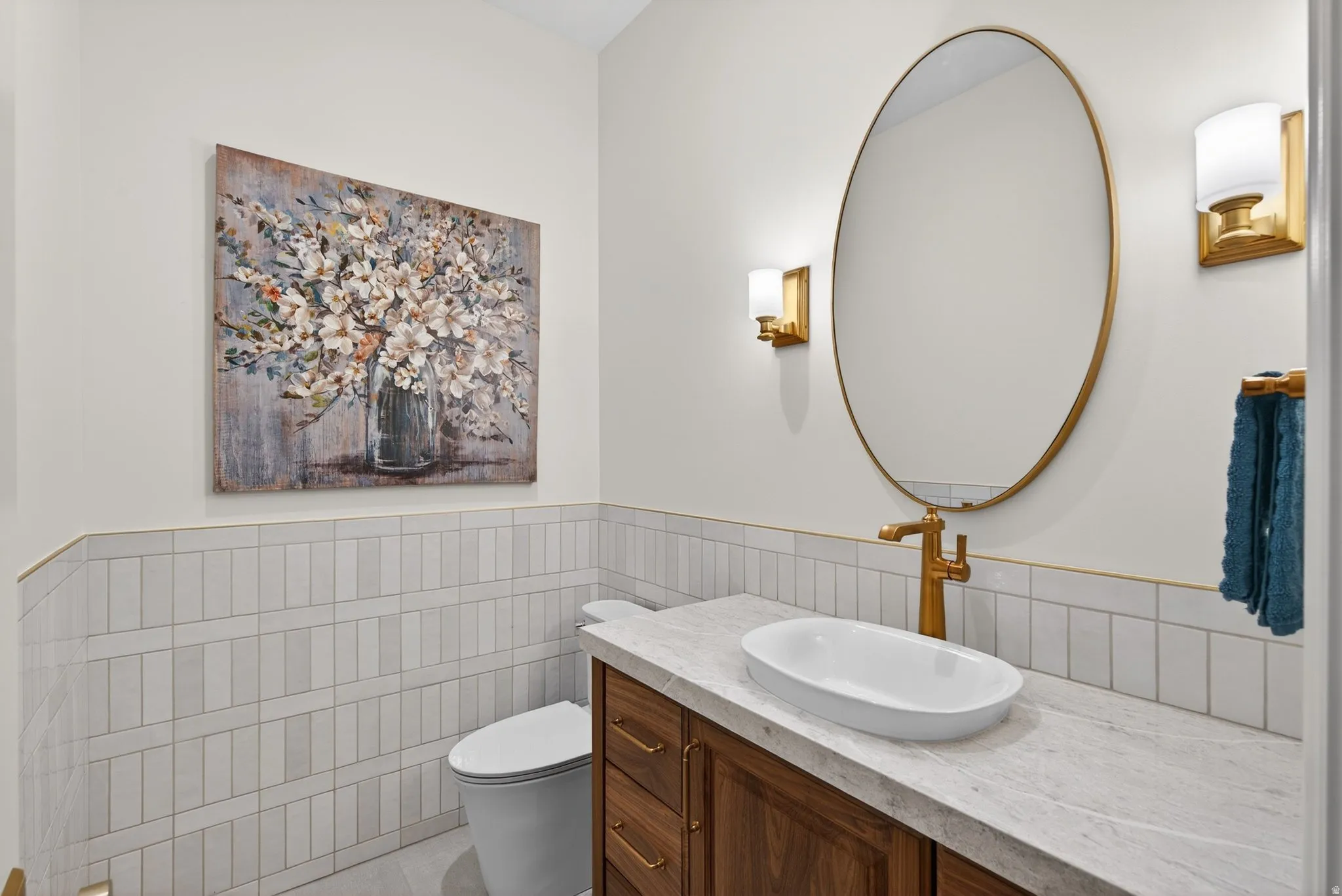 Lower Level Half bath featuring vanity, a wainscoted tile walls