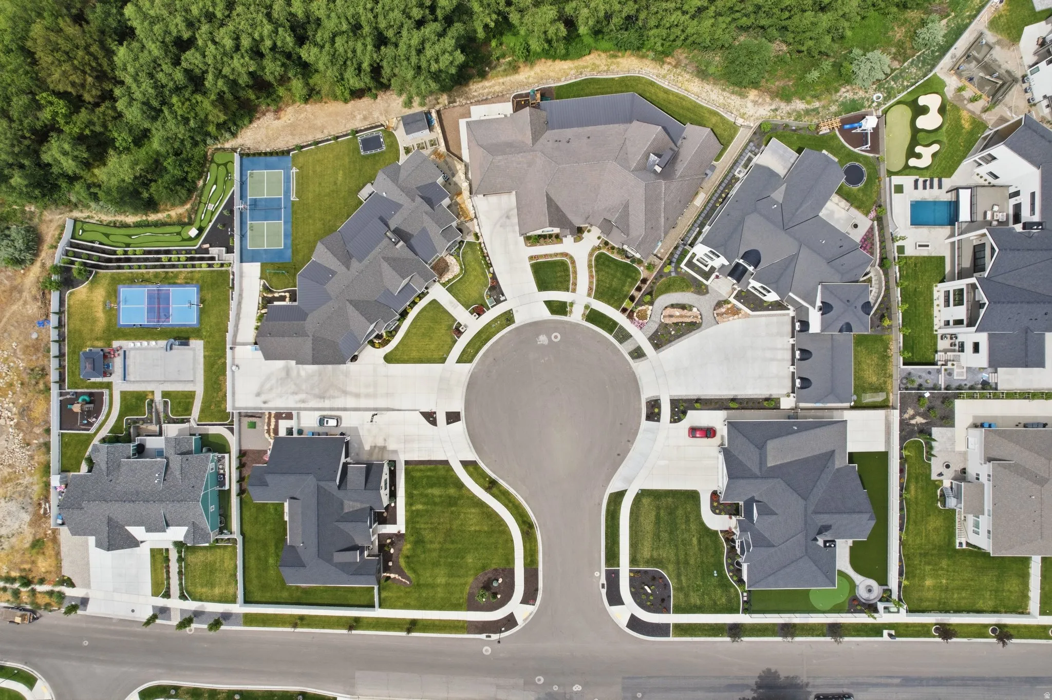 Residential properties arranged around a cul-de-sac, featuring mature trees for private enclosure