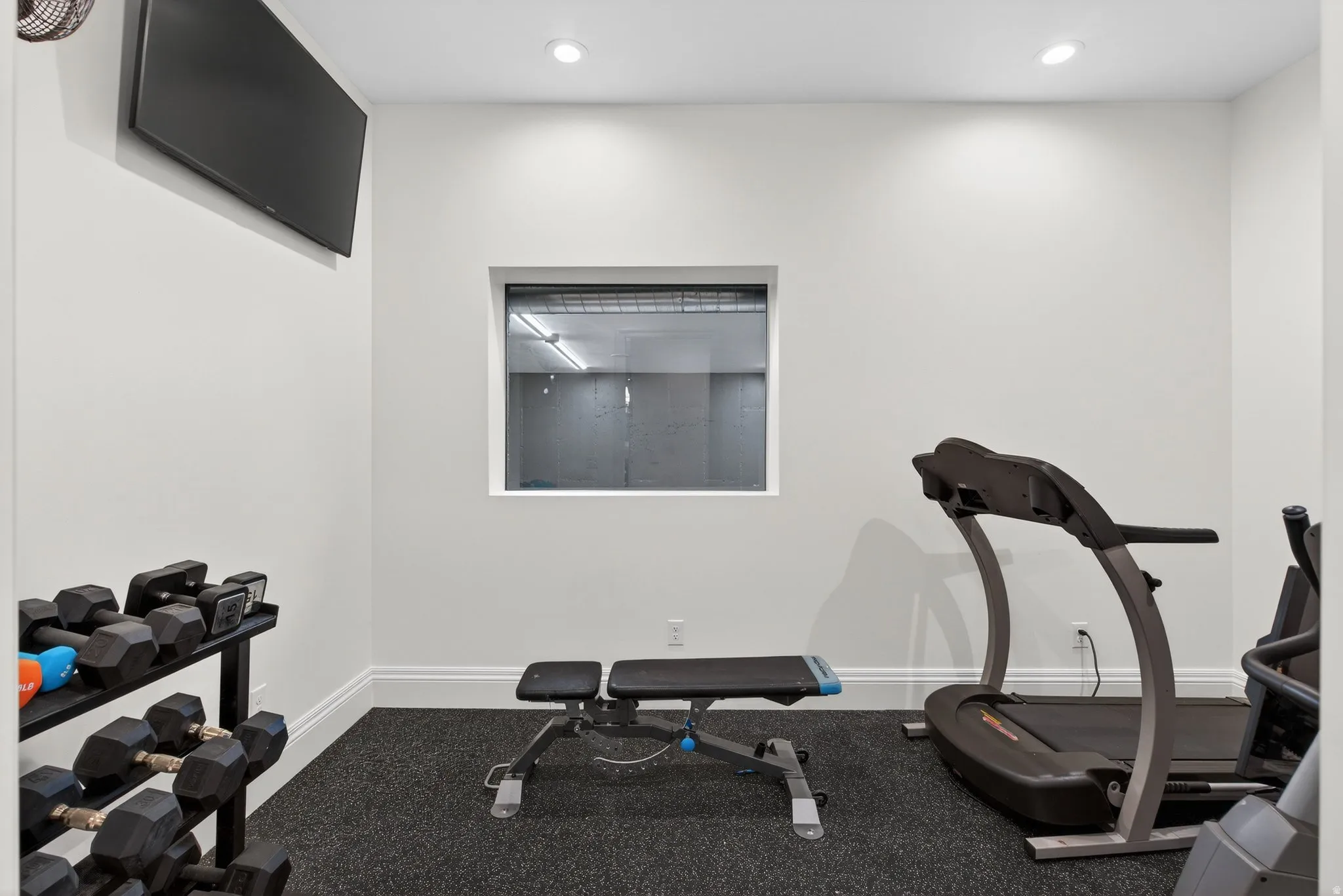 Lower Level Workout area with rubber floor, fan and recessed lighting