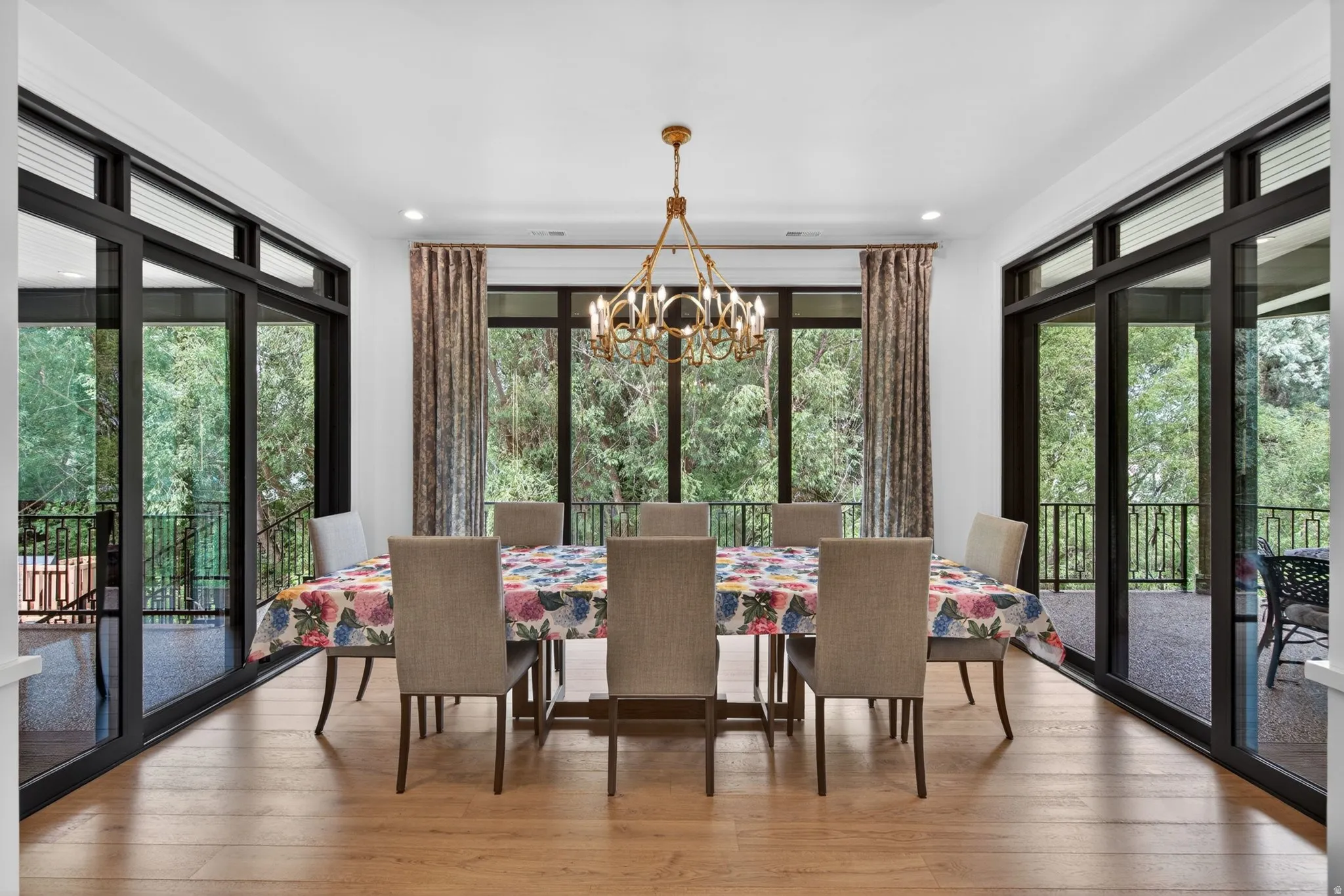 Dining area featuring wood-finish flooring and a beautifully modern chandelier