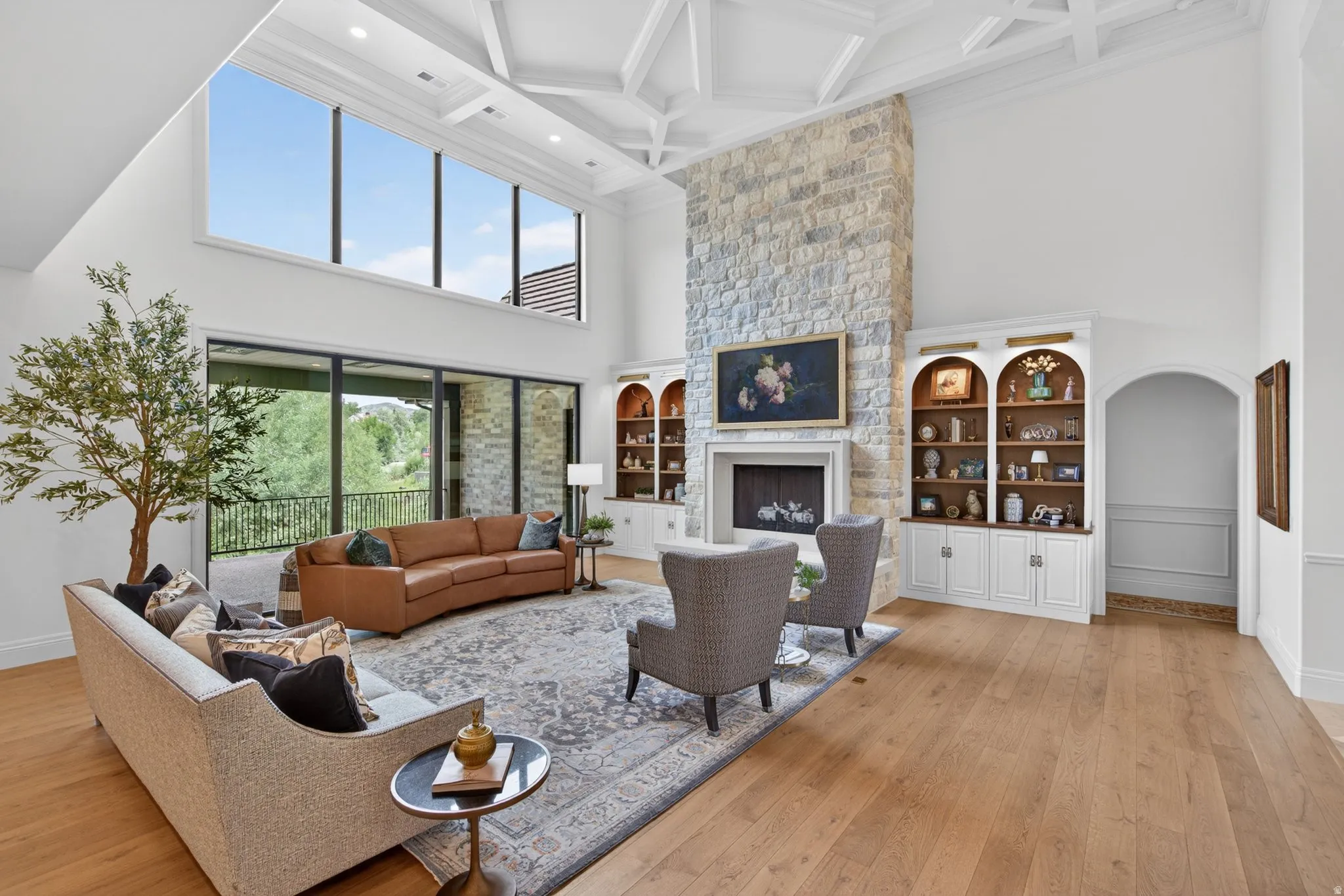 Oak hardwood flooring, real stone fireplace, accent lighting over bookcases