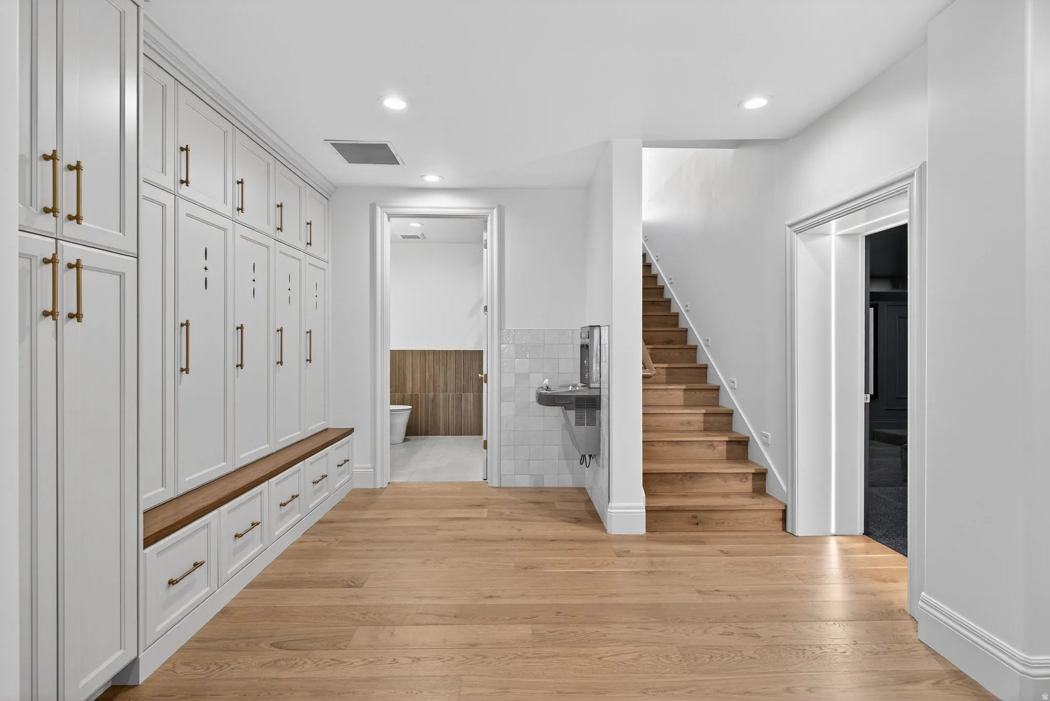 Large Basement Entry features Built-in lockers, drinking fountain, oak hardwood floor