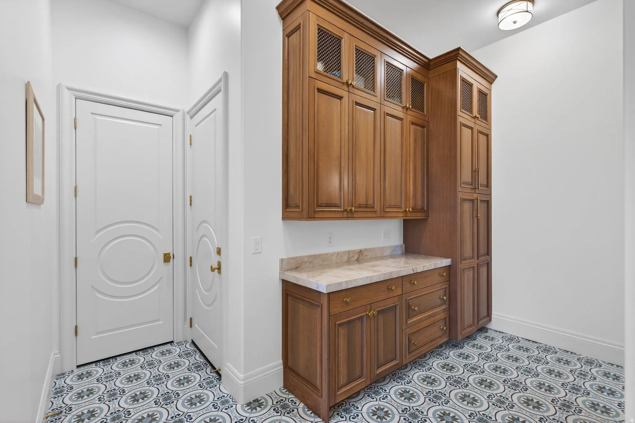 Exit to garage-oak hallway cabinetry
