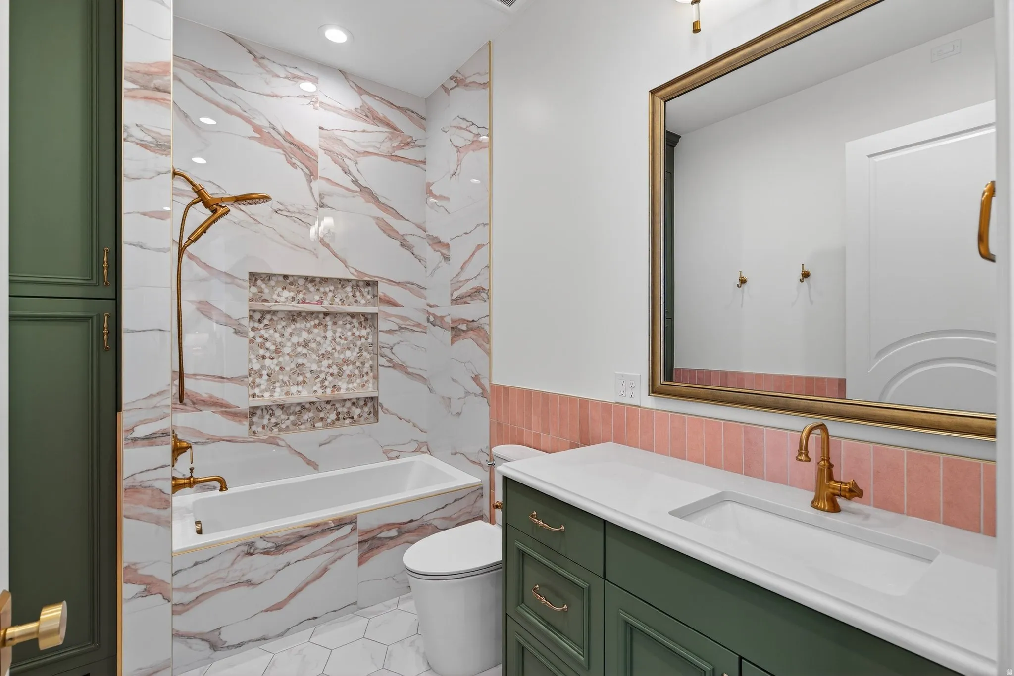 Full bathroom with vanity, deep tub, recessed lighting, tiled half walls