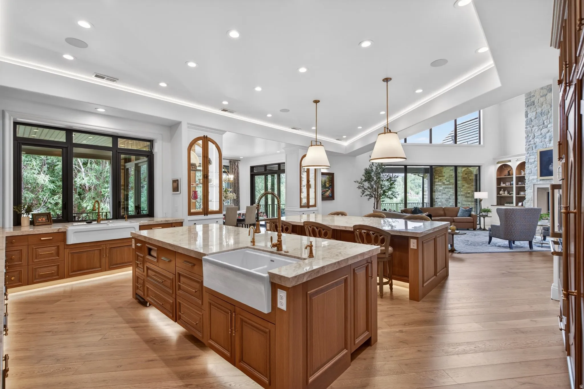 Beautiful Oak cabinets featuring two large islands with seating, 2 farmhouse sinks, and under-cabinet lighting
