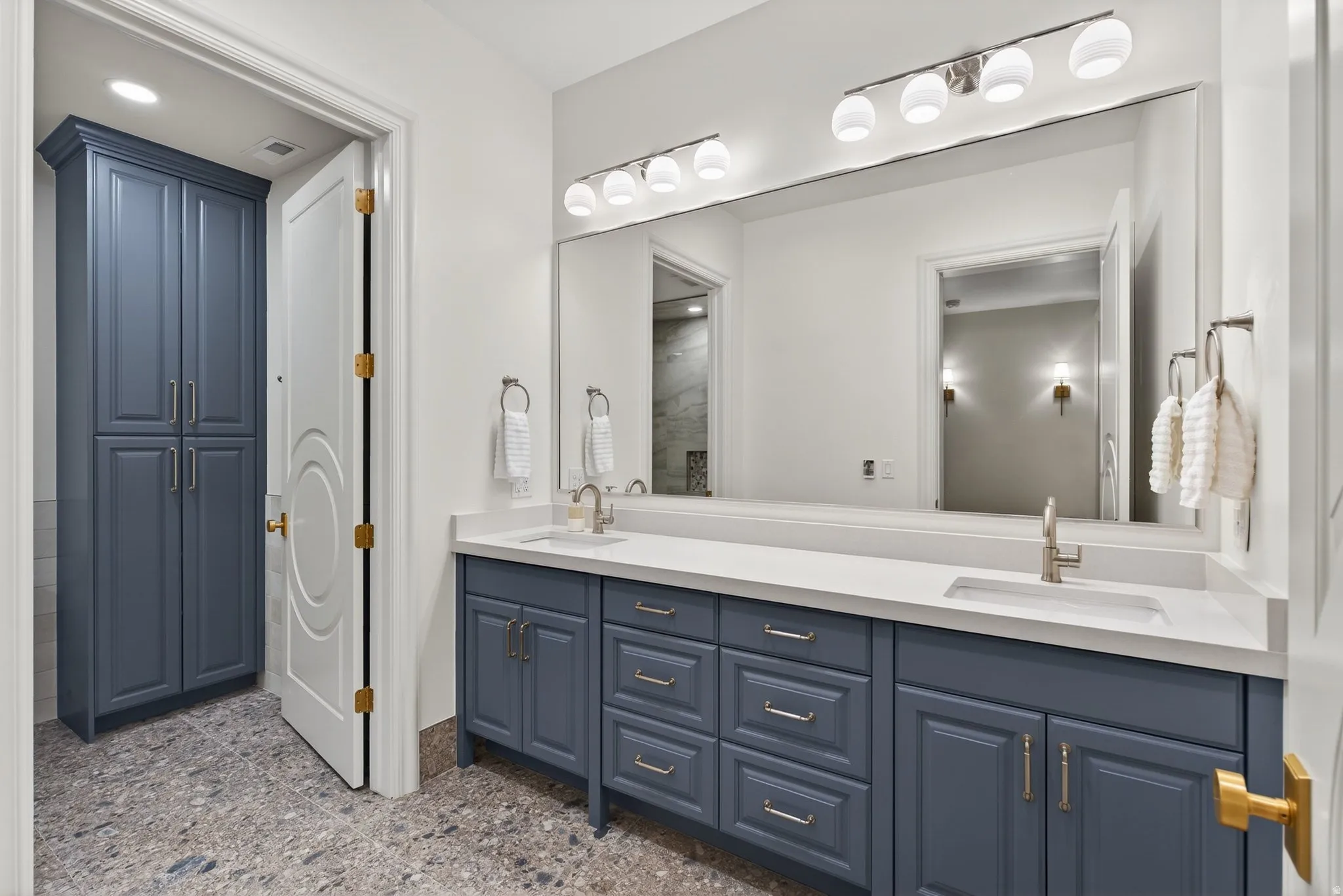Lower Level Hall Bath featuring double vanity, heated floor, separate tub/shower room