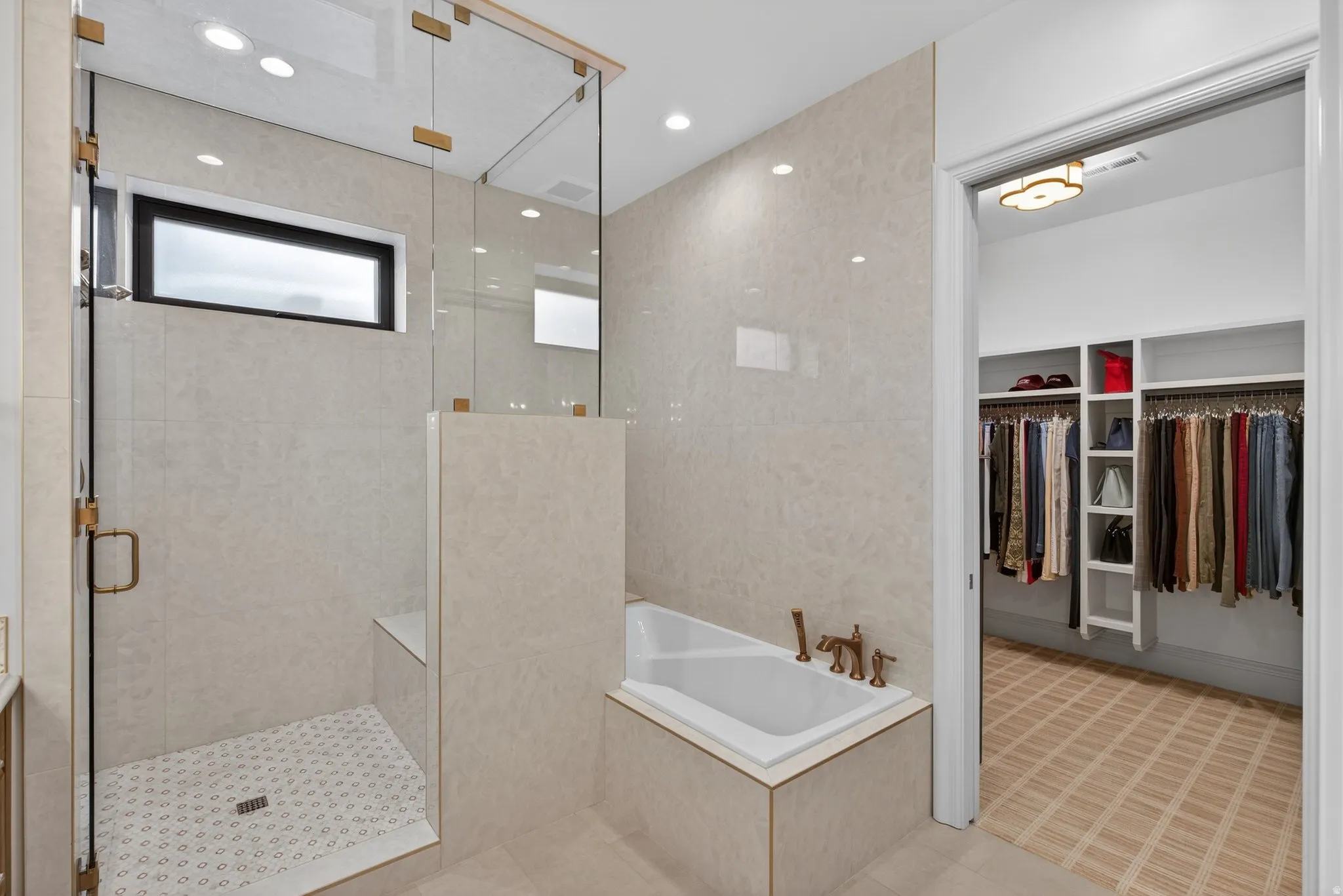 Lower Level Primary Bath Full tiled wall surrounds tub