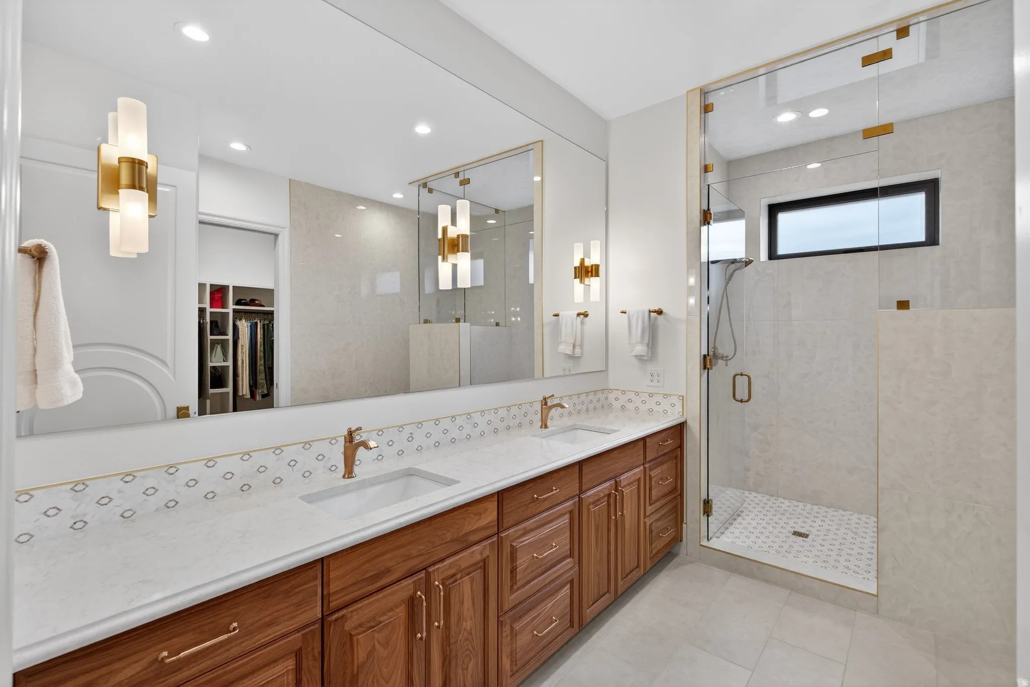 Lower Level Primary bath with double sink vanity, 2 spacious closets, separate tub & shower, tile flooring