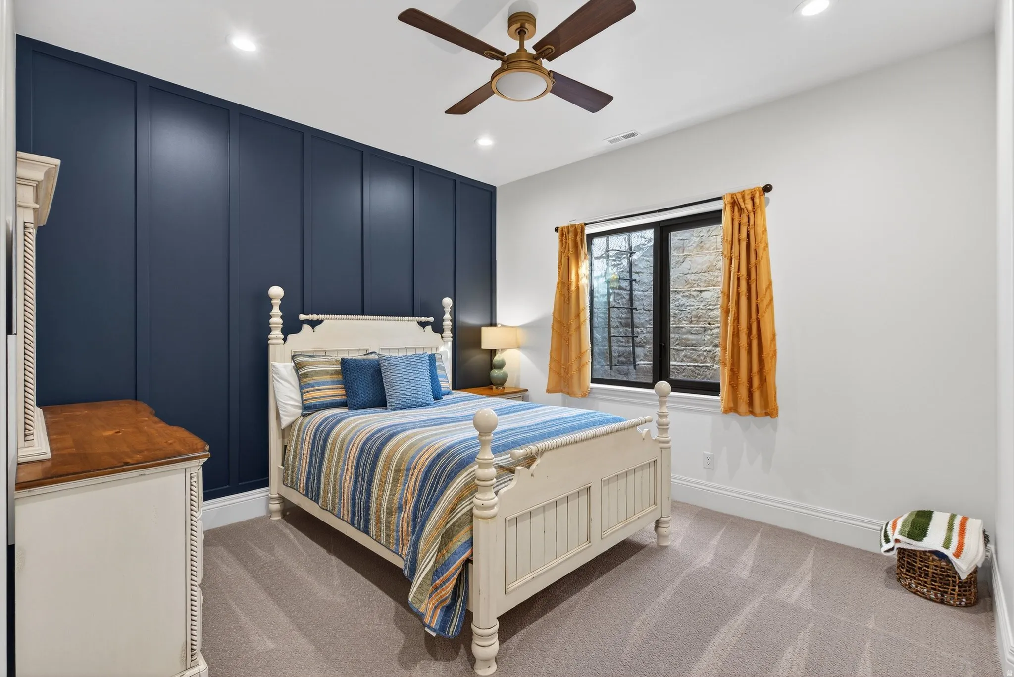 Lower Level Bedroom featuring a decorative wall, light carpet, recessed lighting, and ceiling fan