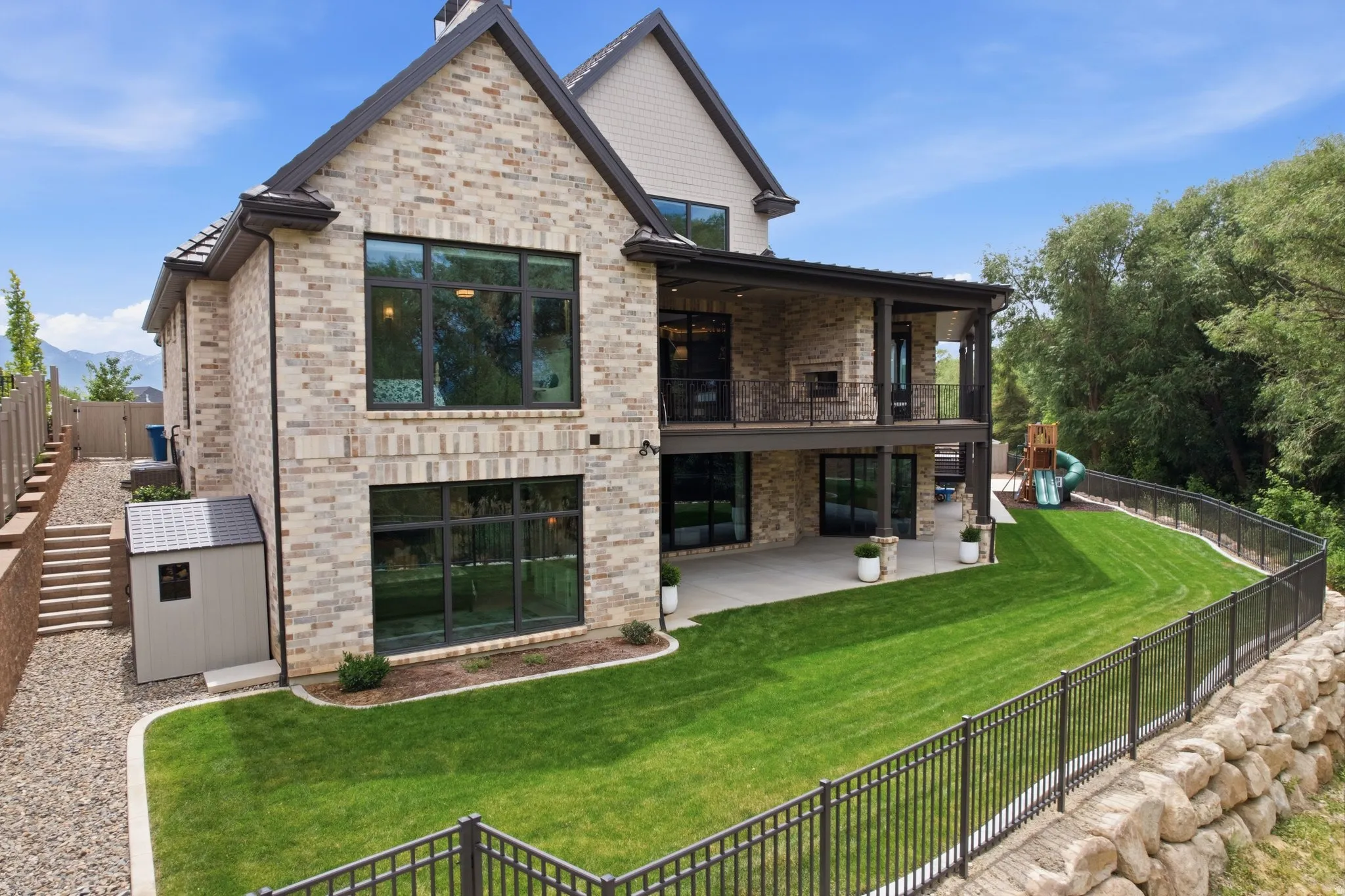 Brick exterior featuring expansive windows and a multi-level design