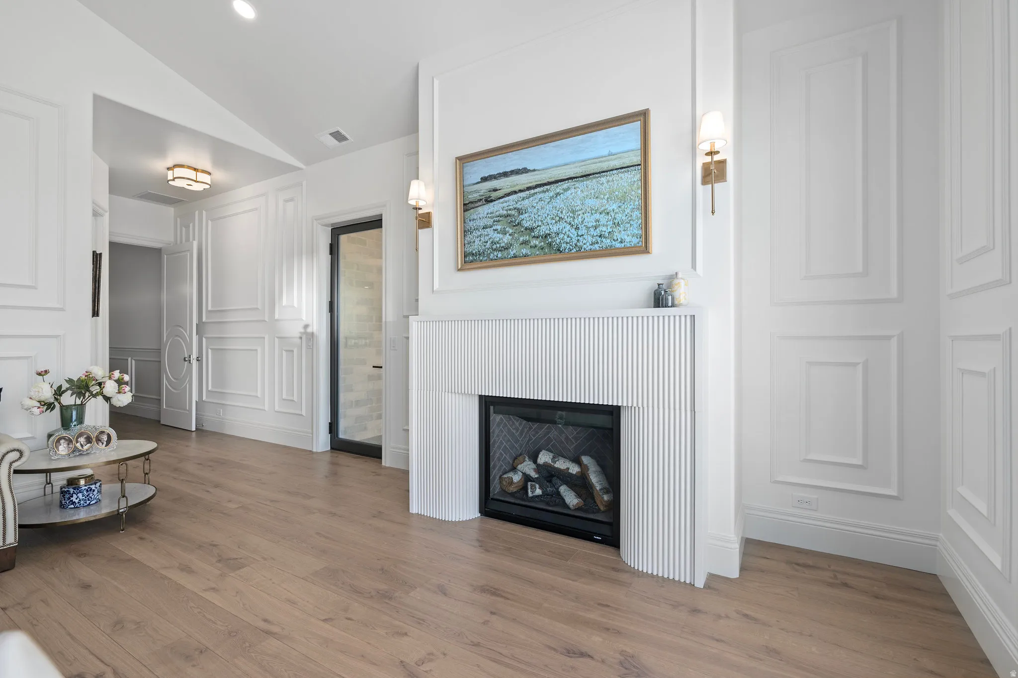 Primary Bedroom-gas fireplace, moldings, exterior door to deck with foggable glass, white oak hardwood floor